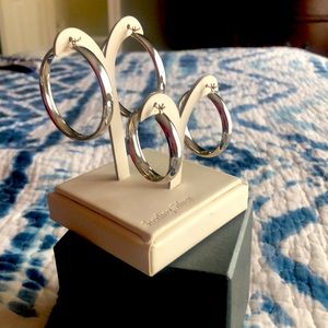 Two pairs of sterling silver hoops.